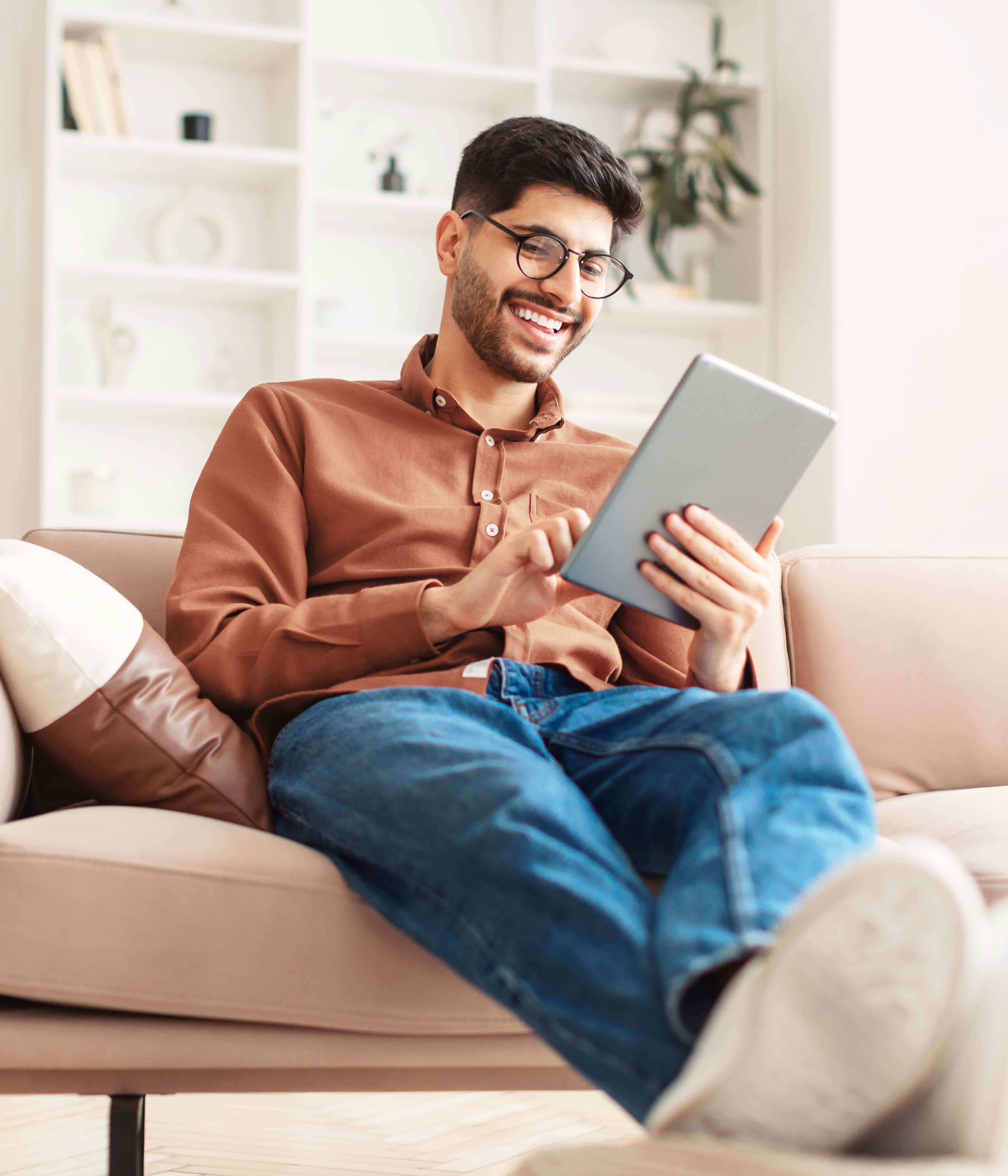 Man signing up for a secondary savings account with CCCU on an ipad