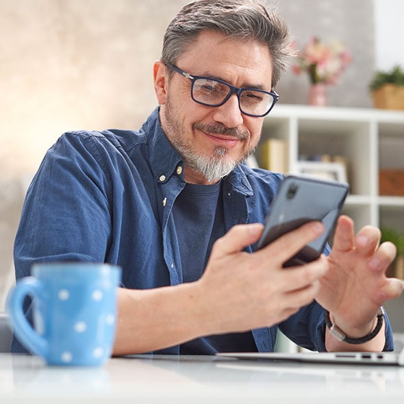 Man on the mobile banking app with CCCU credit union in Portland Oregon.