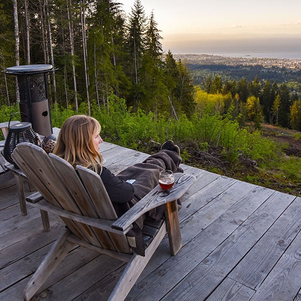 Woman relaxing on her porch with peace of mind because she has a personal loan with CCCU.