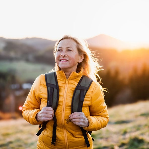 Middle aged woman hiking who has peace of mind because she has an IRA with Consolidated Community Credit Union Portland Credit Union.