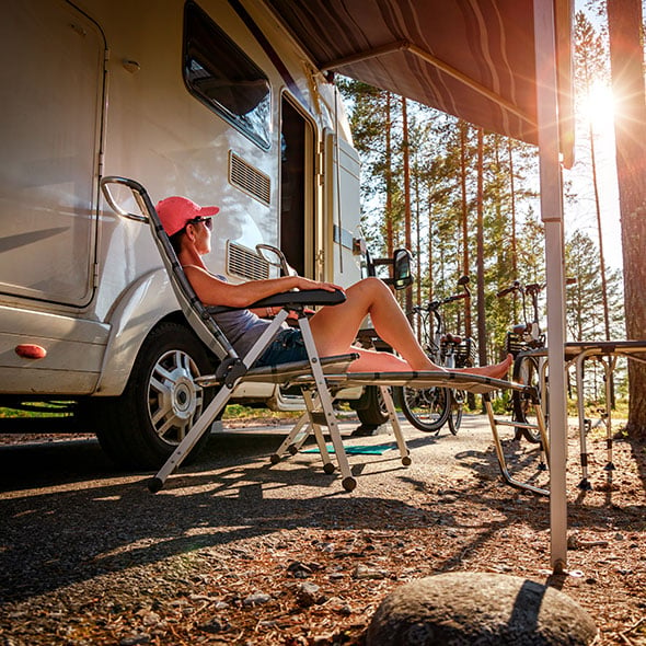 Woman relaxing in front of her RV on a camp trip in Portland Oregon.
