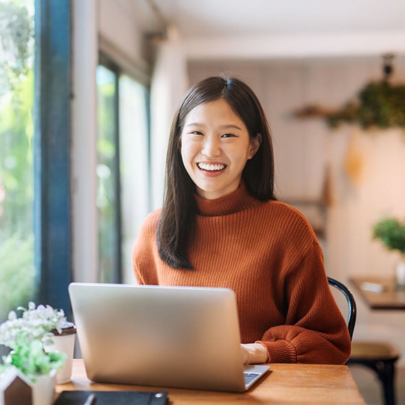 Young woman on computer joining Consolidated Community Credit Union in Portland Oregon.