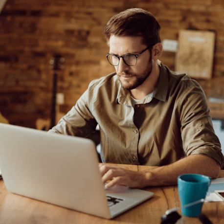 man using CCCU online bill pay on his laptop