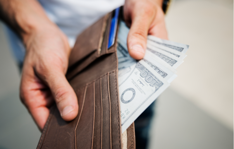 money in a wallet from good spending habits