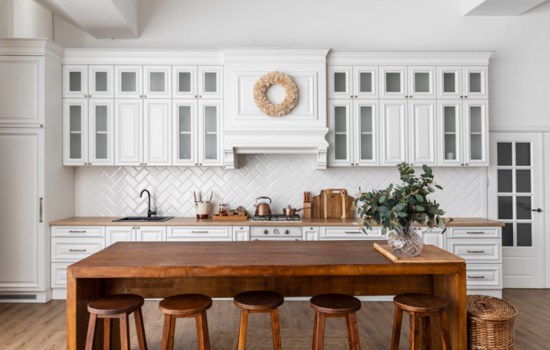 renovated white kitchen with wood counters