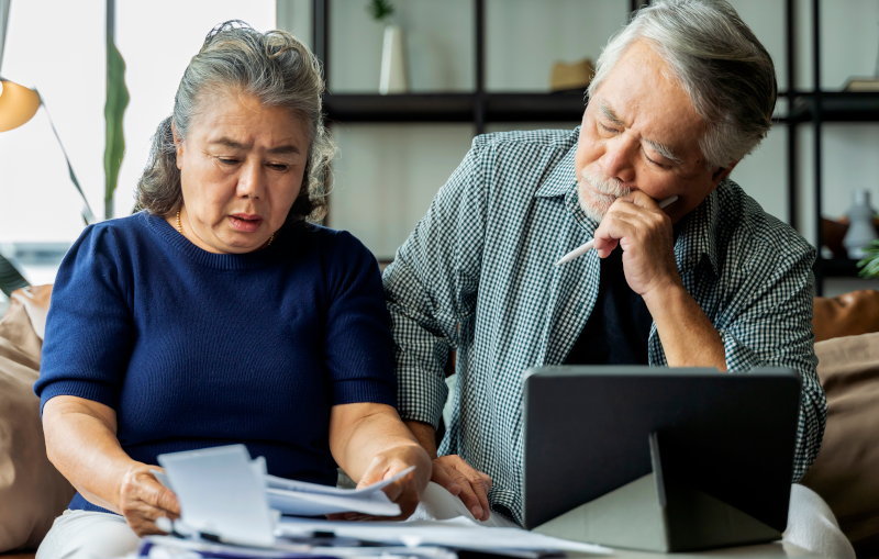 senior couple worried about bills and debt