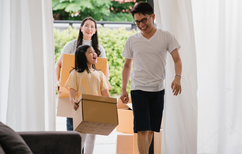 young asian family moving into their new house