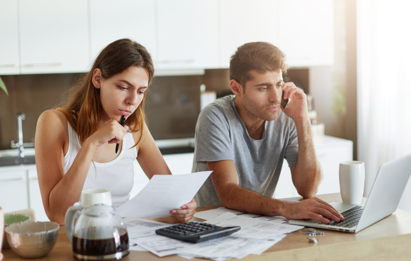young couple worrying about their debt