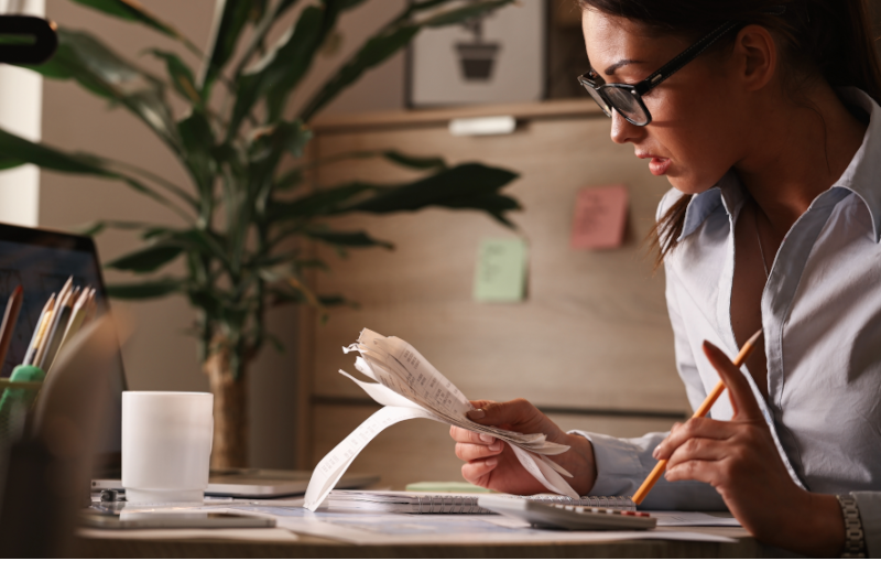 young woman calculating receipts and expenses for her budget